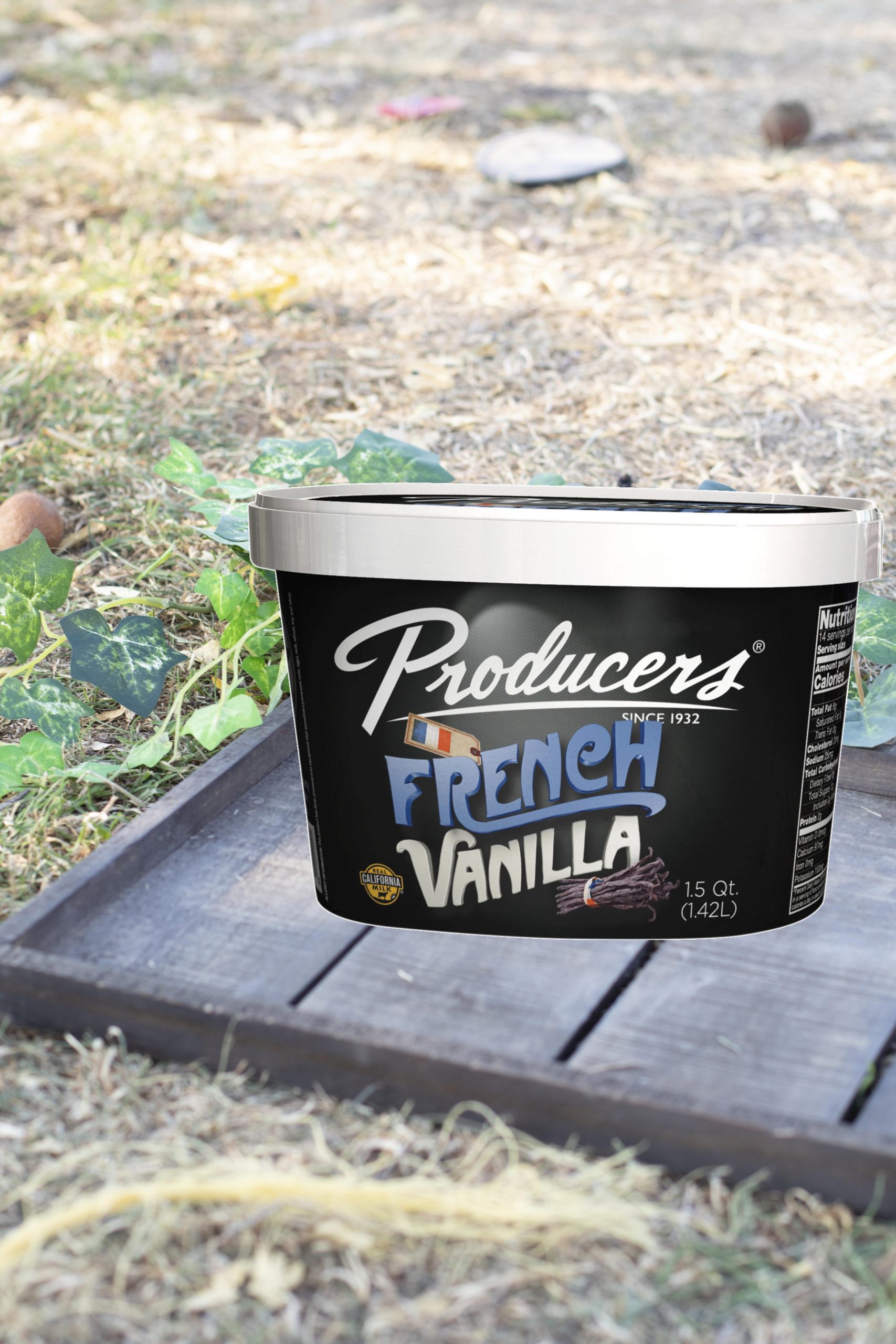 French Vanilla Producers Ice Cream sitting on wood on top of grass.