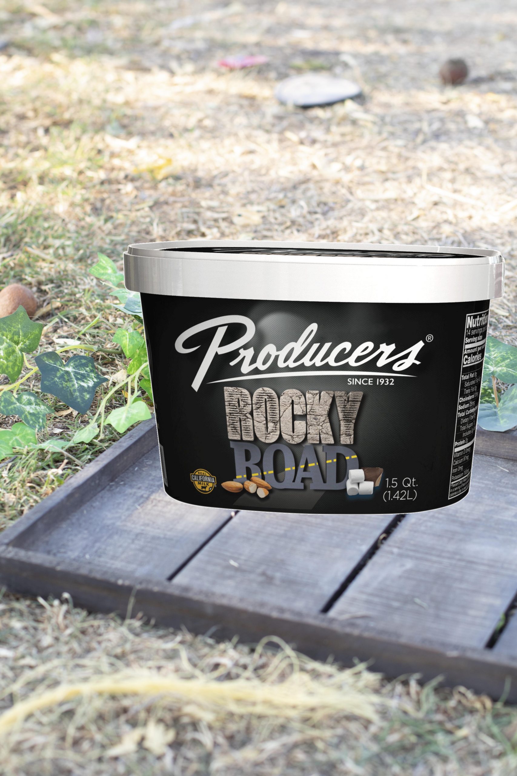 Rocky Road Producers Ice Cream sitting on wood on top of grass.