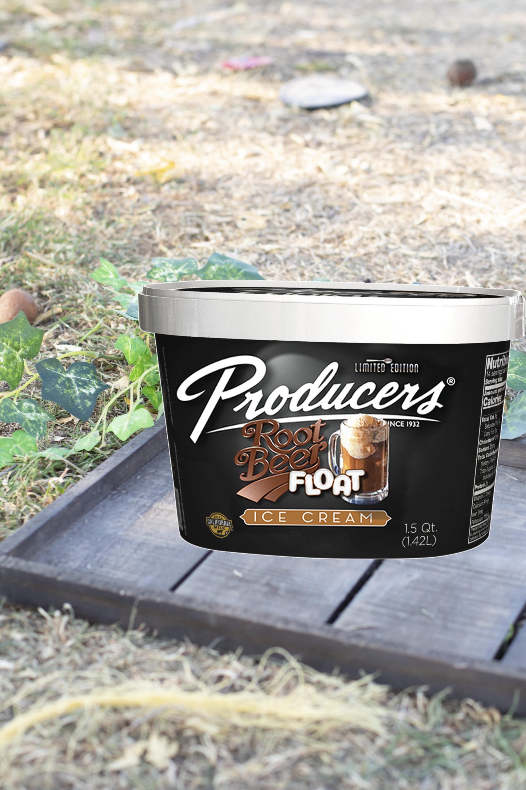 Root Beer Float Producers Ice Cream Container sitting on wood on top of grass.